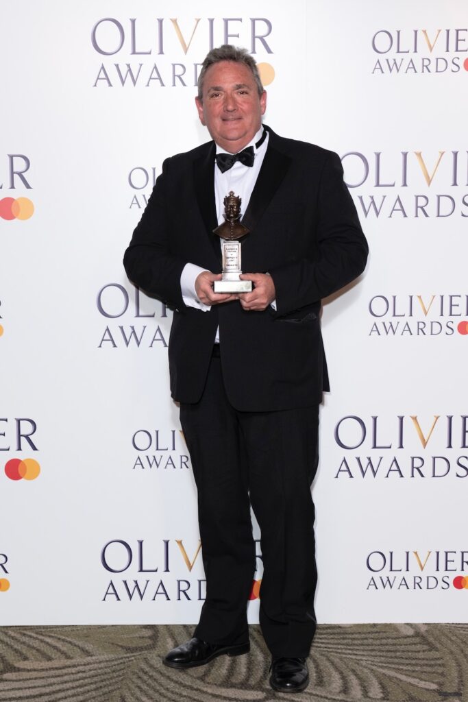 Nick Lidster, winner of the Best Sound Design award for "Fiddler On The Roof", poses in the Winners Room at The Olivier Awards 2025 with Mastercard