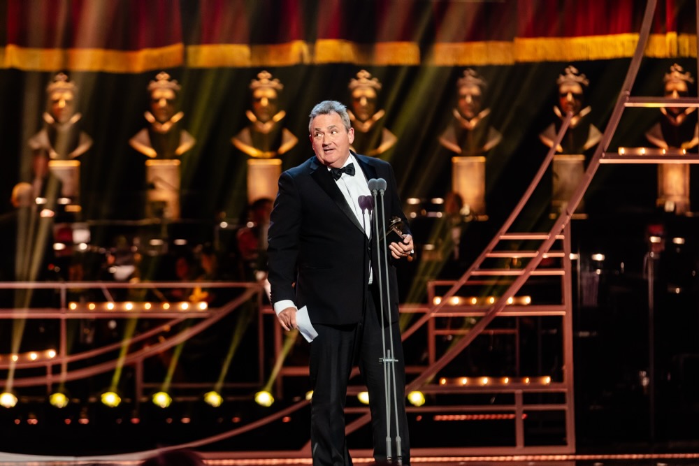 Nick Lidster, winner of the Best Sound Design award for "Fiddler On The Roof", poses in the Winners Room at The Olivier Awards 2025 with Mastercard